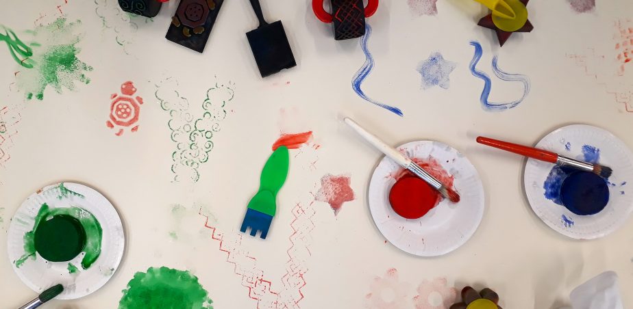 Image of paper with sponge rollers and paint. With paint marks on the paper