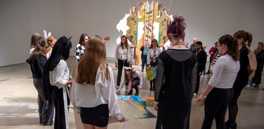 A Group of transition year students stand around an artwork in VISUAL Carlow