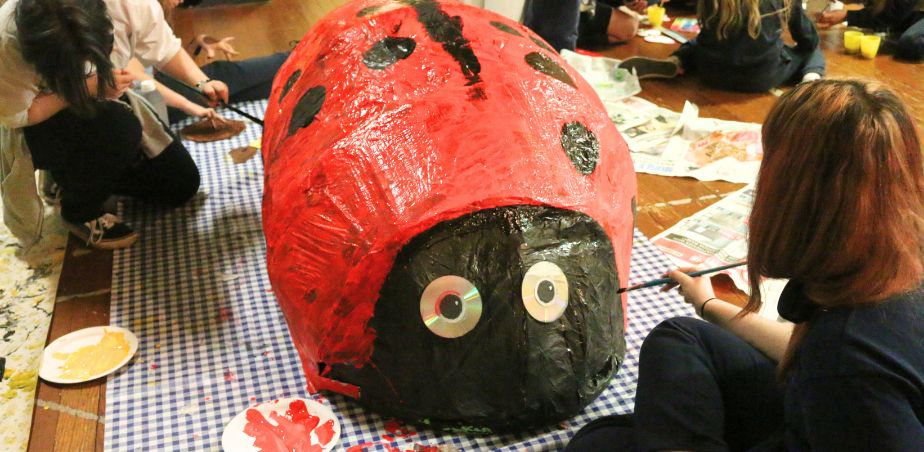 Students paint a red giant ladybird for Marino 100
