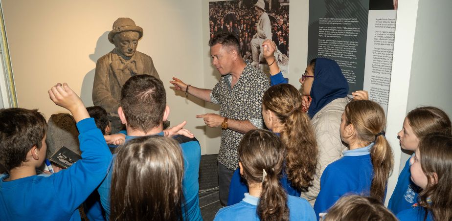 Brendan McGowan, Museum Education Officer sharing the story of Pádraic Ó Conaire with school children visiting the Galway City Museum