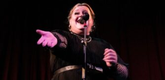 Singer Wren Dennehy sings into a microphone. Wren delivers CPD workshop for teachers at the Ark