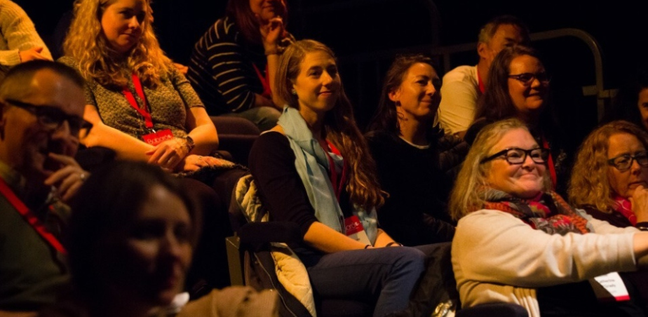 Audience sit in a darkened theatre space at Baboró International Festival for Children 2025