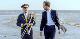 Two musicians on a beach for The Marching Band (En Fanfare) Schools screening at Cork Film Festival