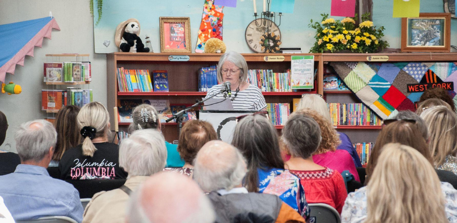 Woman reading for audience at West Cork Literary Festival