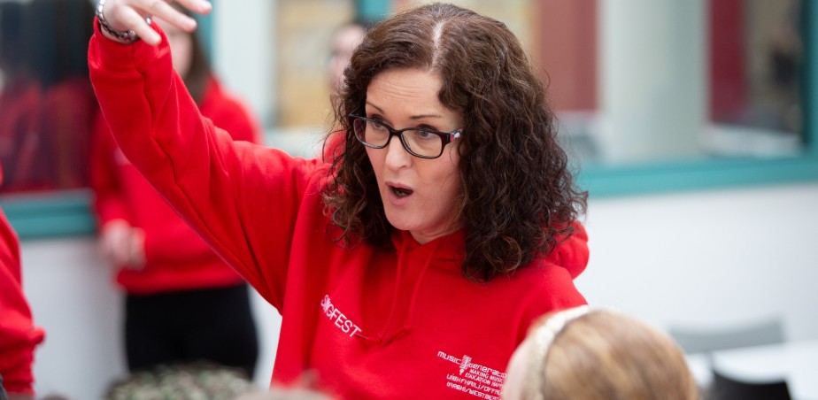 Image copyright Music Generation - Musician and tutor Ger Relph with members of the Music Generation Offaly Westmeath Singfest Community Choirs. Image Barbara Flynn